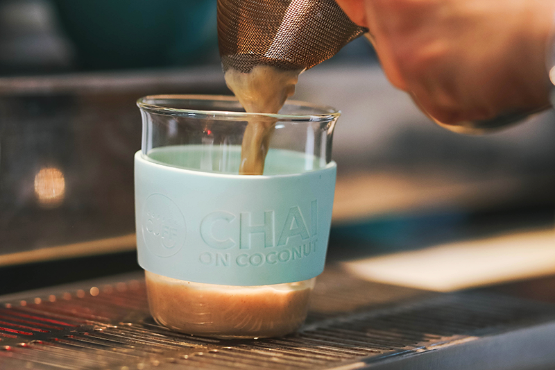 chai coffee in reusable keep cup poured by barista