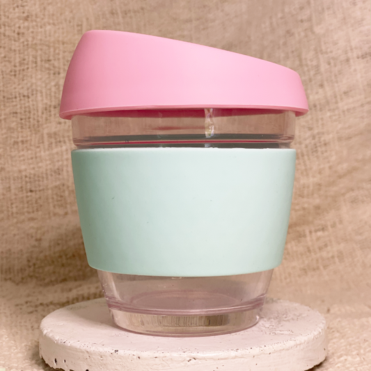 Pink and mint reusable glass coffee cup with personalised custom sleeve