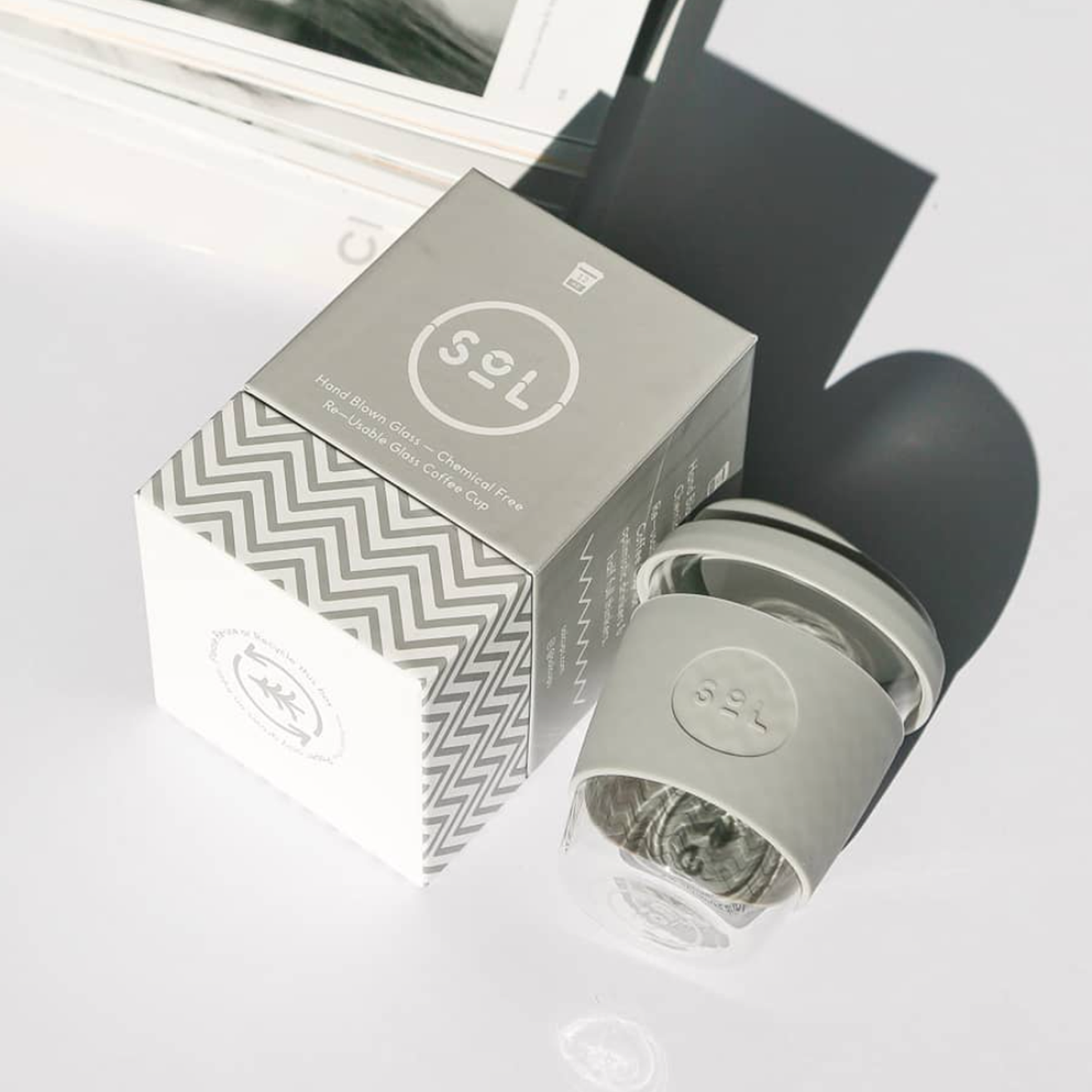 Reusable SoL glass cup and personal sleeve in grey