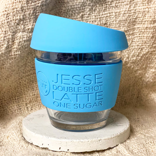 Small blue reusable glass coffee cup with personalised custom cuff