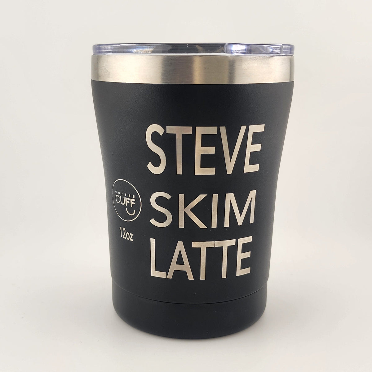 A black insulated tumbler with a clear lid and a stainless steel rim, featuring the text 'STEVE SKIM LATTE' in cream lettering. A small circular logo on the left reads 'Cliff' and '16oz'.