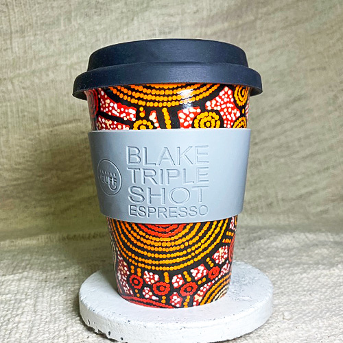 Reusable porcelain cup by Aboriginal artist Teddy Gibson with custom cuff