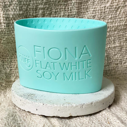 mint coffee cup sleeve with customer name and Coffee order with flat white soy milk