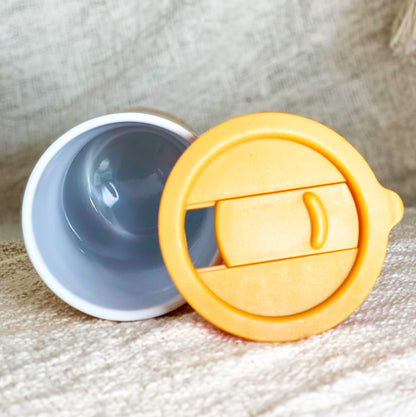 reusable keep cup travel mug in mustard with name and coffee order in a ceramic cup